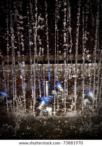 Night fountain throwing up water drops, night color illumination