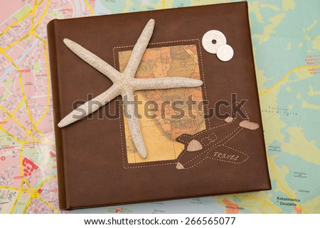 Star fish on travel diary with map background