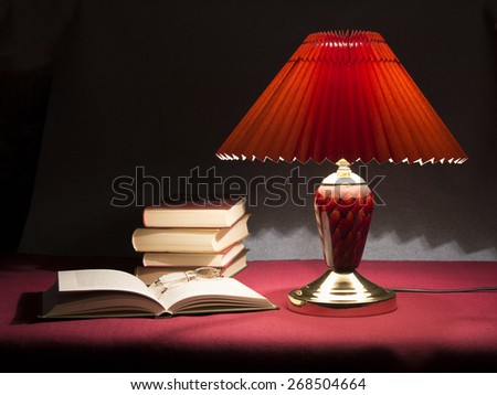 Reading of books In lamp light at home or library