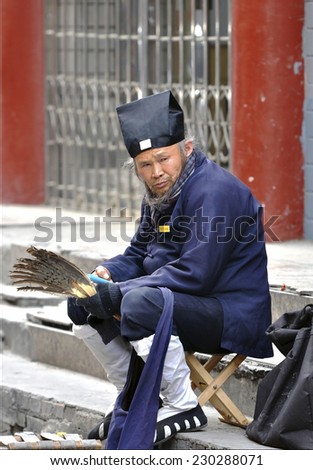 BEIJING - NOV 21: Old man in the national costume in Beijing on november 21 2013 in China.