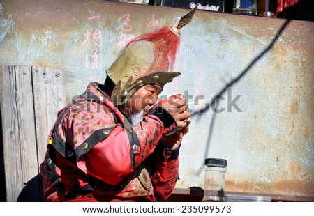 BEIJING - 08: Old Chinese man eating outdoors in Beijing on November 08.2013 in China