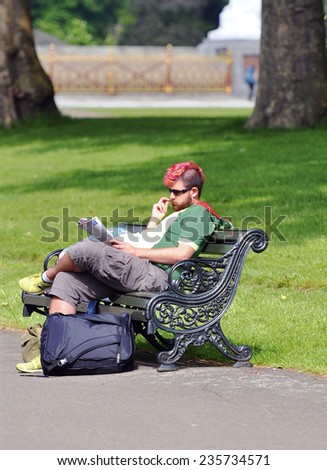 LONDON - MAY 15: Man reading at the Hyde park in London on May 15.2014 in England.