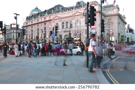 LONDON - MAY 15: People and traffic in Piccadilly Circus in the evening on May 15.2014 in UK. A famous space in London's West End, it was built in 1819 to join Regent Street with street off Piccadilly