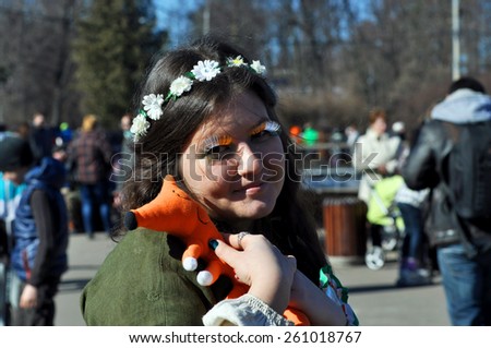 MOSCOW - MAR 14: Smiling girl with fox during St Patrick\'s day party in Moscow on March 14. 2015 in Russia