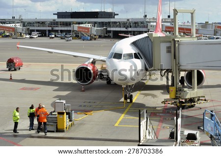 AMSTERDAM - APR 27: A plane is parked at the boarding gate at the Amsterdam Airport Schiphol on April 27. 2015 in Netherlands