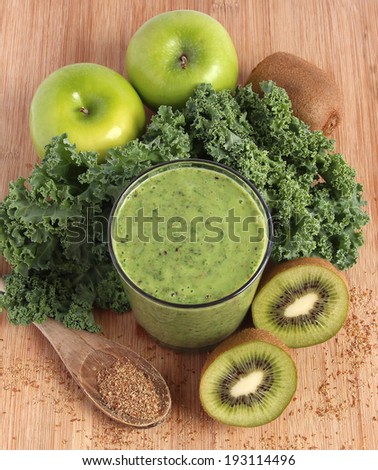 Green smoothie made with kale, kiwi, green apples and ground flax seeds