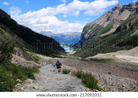 LAKE LOUISE, ALBERTA, CANADA - AUGUST 27, 2014: People hiking on the Plain of the Six Glaciers hiking trail near Lake Louise, Banff National Park, Alberta, Canada