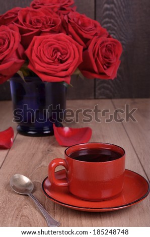 Bouquet of withered roses and coffee cup