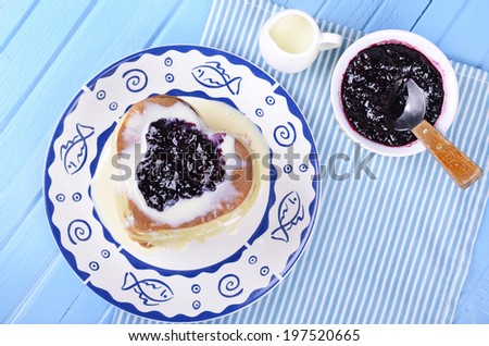 Heart shaped pancakes with condensed milk and jam