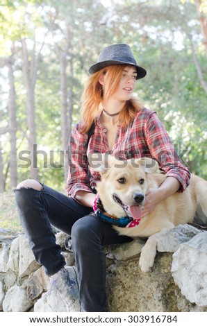 Modern girl with hat and her dog