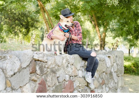Modern girl with hat and her dog