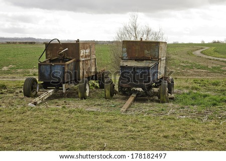 rusting farm machinery in a field