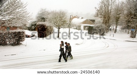 KINETON, WARWICKSHIRE, ENGLAND - FEBRUARY 6; Children walk to school through snow during the worst snow in the UK in 20 years on February 6, 2009 in Kineton, Warwickshire, England.