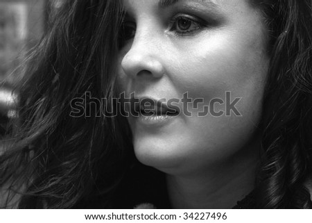 Beautiful black and white picture of a brunette woman having her hair dresses