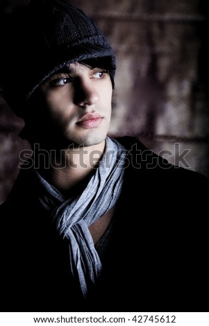 an edgy dark young man in a fashionable pose