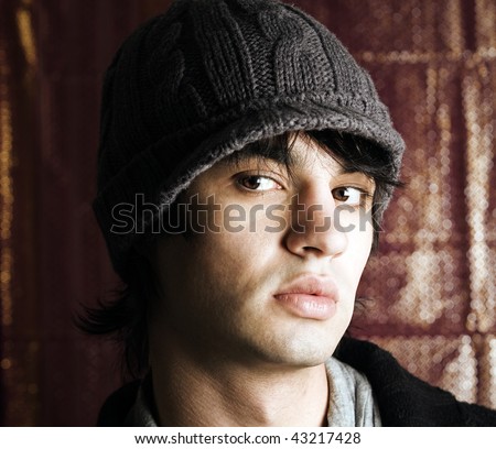 edgy shot of a young man in a hat