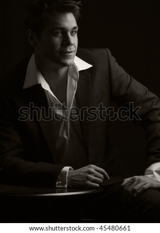 a sepia toned low key dramatic bar scene of a young man in 1930s dress