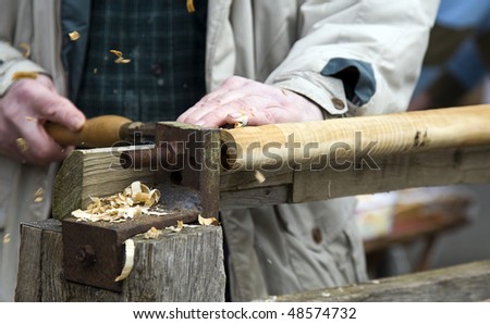 a lathe being turned manually and worked traditionally