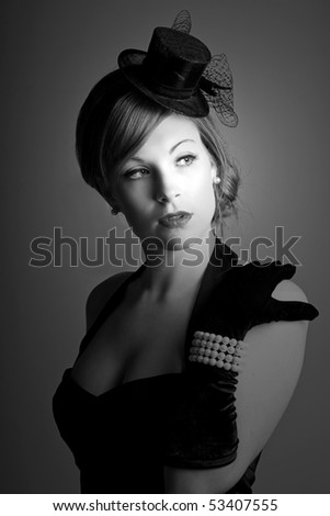 a beautiful 1930s styled woman in a low key black and white setting