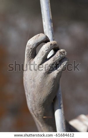 hand clasping a staff