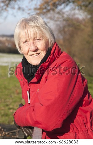 beautiful winter picture of a senior blonde woman in the snow