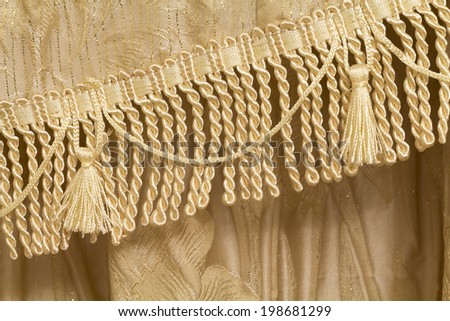 Detail of curtains with fringe and tassels, background