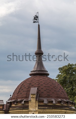Weather vane on a building dome spike with Georges the Victorious\'s silhouette