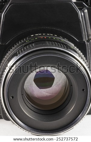 Camera lens with iris closeup on white background