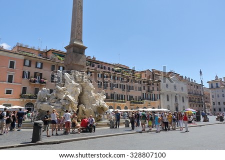 Rome, Italy - August 18, 2015: People near the Fountain of the four Rivers with Egyptian obelisk, in the middle of Piazza Navona in Rome, Italy
