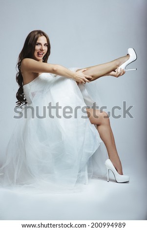 Young beautiful bride in a white wedding dress with long brown hair