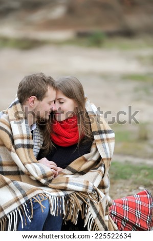 lovers sit on a snag and are heated