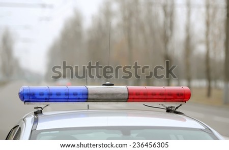 flashing indicators on a roof of the police car costs