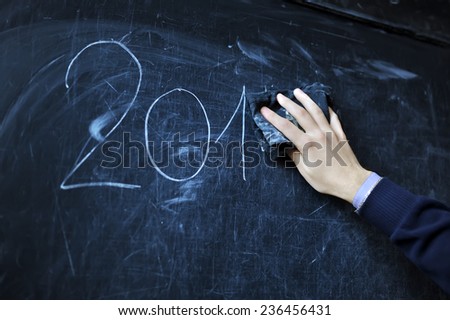 the student writes on a board with a white chalk - 2014