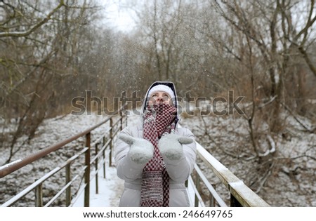 the woman goes on the bridge and holds the skates in hand