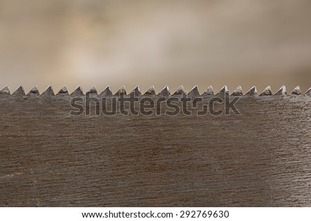 Macro shot of teeth on an old hand saw blade.