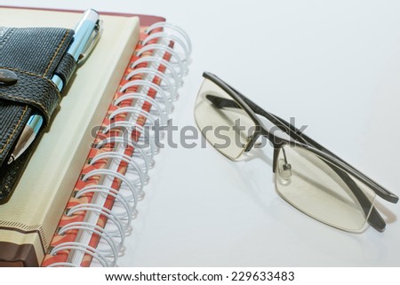 Note book pen and glasses stationery business training