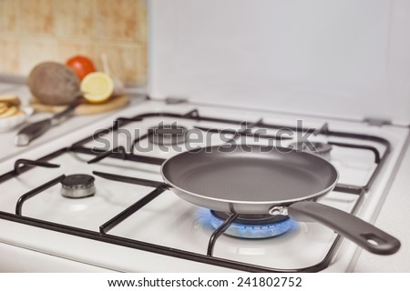 empty pan on the stove burning flame