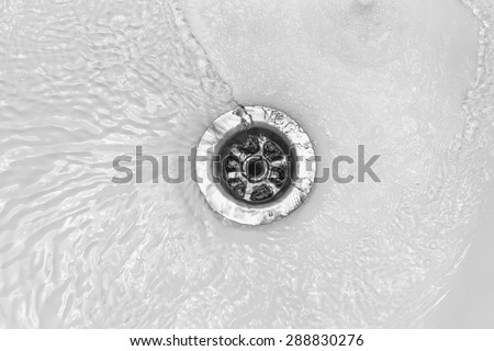Water flows into the drain enamel sink