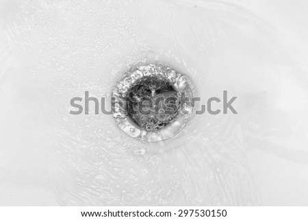 Water flows into the drain enamel sink