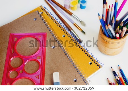 notebooks and pencils, paints, compass, ruler, Eraser, brush, white background