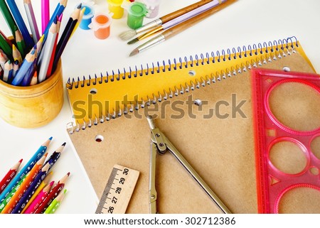 notebooks and pencils, paints, compass, ruler, Eraser, brush, white background