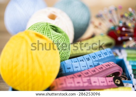 Sewing with color threads, meter and scissors