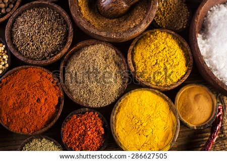 Spices and herbs in wooden bowls