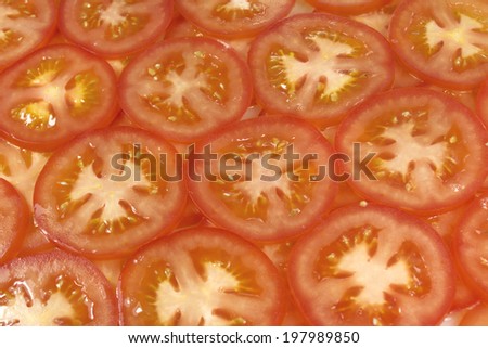 Healthy natural food, background. Tomatoes slices. More background of fruits and vegetables