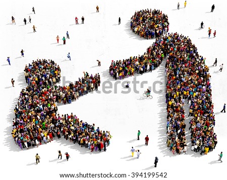 Large and diverse group of people seen from above gathered together in the shape of helping gesture