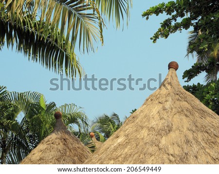 Traditional roof house in Africa, made ??of grass and beautifully bonded ceramic pot on top
