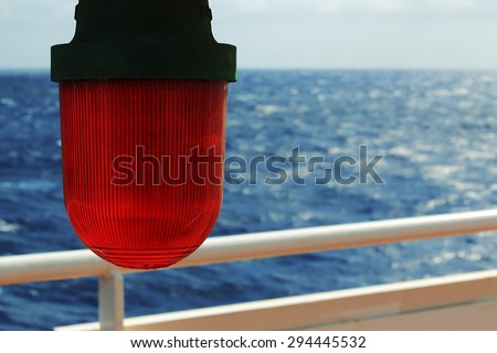 red marine emergency lantern on the background of sea waves