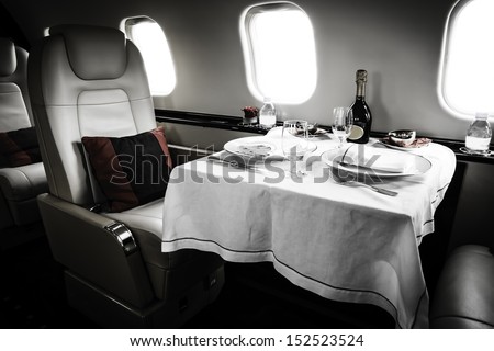 Luxury Business Jet Interior with served table and leather chair