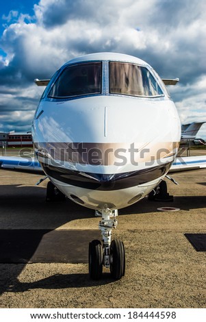 Luxury Business Private Jet plane at airfield toned in blue