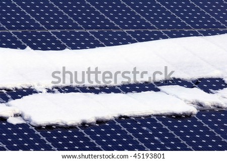 solar panels on a roof in winter with snow
